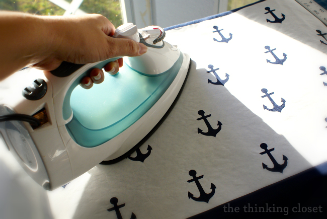 Ironing your freezer paper stencil.