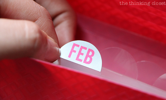 Using printable foil stickers to label tabs in an accordion file organizer.