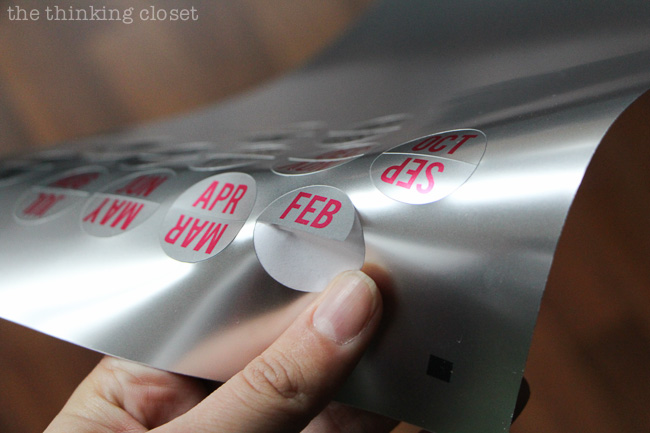 Using printable foil stickers to label tabs in an accordion file organizer. Using printable foil stickers to label tabs in an accordion file organizer.