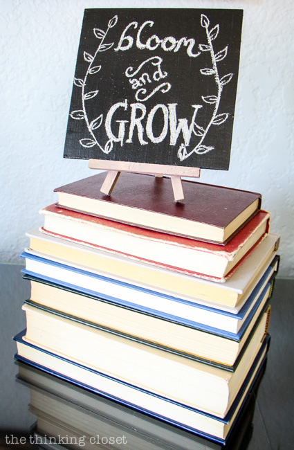 Rustic Vintage Spring Mantel: Vintage books are the perfect platform for displaying a DIY chalkboard! via thinkingcloset.com Rustic Vintage Spring Mantel: Vintage books are the perfect platform for displaying a DIY chalkboard! via thinkingcloset.com