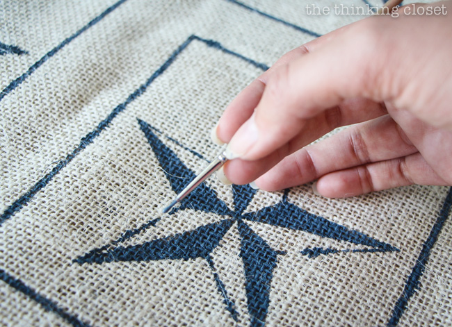 Adding final touch-ups to the nautical star burlap squares. Adding final touch-ups to the nautical star burlap squares.