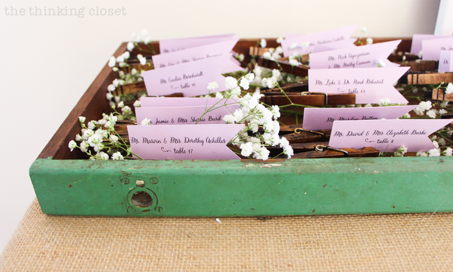 DIY Rustic Vintage Clothespin Place Card Holders | Love that can save on cost, but not scrimp on beauty with these gems! Step by step photo tutorial includes instructions on the easy method of staining the clothespins and how to design and cut the place card flags. Pop 'em in a vintage drawer with baby's breath and voila! Instant wedding whimsy!