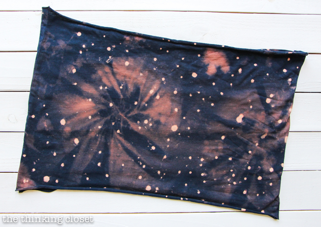 DIY Galaxy Print Infinity Scarf: Just one of the many inspirational tutorials during Scarf Week 2015.  This creative project uses the power of bleach on a dark t-shirt to transform it into a fabulous galactic accessory!  And you likely have most the supplies you'd need already lying around the house!  