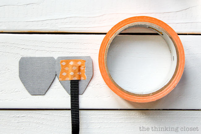 Securing the nylon connector to the leather piece with masking tape. Just another step in the DIY Scarf Camera Strap Tutorial: Upcycle a scarf into a snazzy camera strap that will quickly become your new favorite accessory. This sewing tutorial will walk you through each step of the fun refashion. Happy Scarf Week 2015! Securing the nylon connector to the leather piece with masking tape. Just another step in the DIY Scarf Camera Strap Tutorial: Upcycle a scarf into a snazzy camera strap that will quickly become your new favorite accessory. This sewing tutorial will walk you through each step of the fun refashion. Happy Scarf Week 2015!