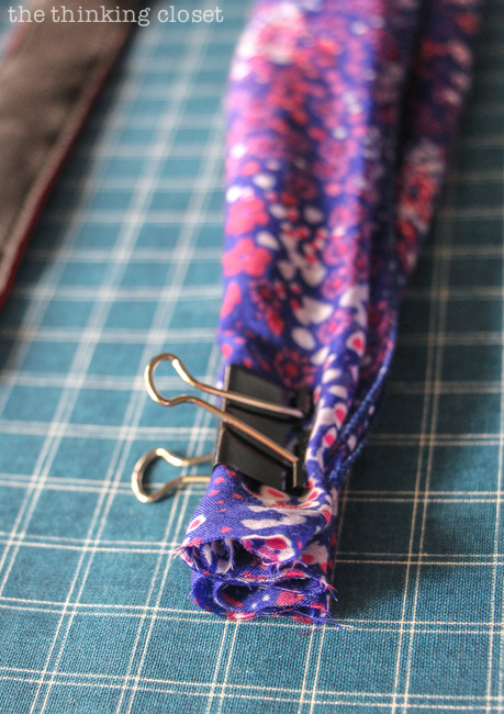 Prepping the scarf!  Just another step in the DIY Scarf Camera Strap Tutorial: Upcycle a scarf into a snazzy camera strap that will quickly become your new favorite accessory. This sewing tutorial will walk you through each step of the fun refashion. Happy Scarf Week 2015!