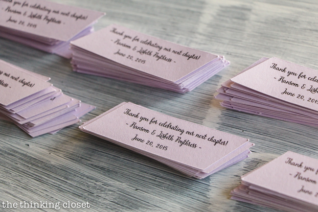 DIY Bookmark Wedding Favors - - perfect for the book-lovin' bride and groom! And you can't beat a price-point of 50 cents per bookmark! Here are the "sleeve" cut-outs for the front of the bookmark, which said, "Thank you for celebrating our next chapter." A most fitting pun for this bookish favor.
