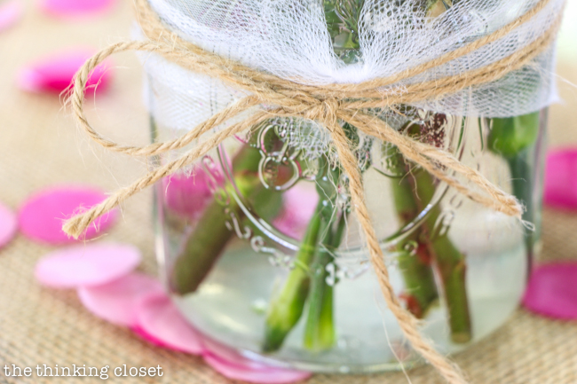 "Cute as a Button" Baby Shower | DIY & Handmade Baby Shower Ideas to Inspire a Party to Remember! Burlap table runners, mason jars with DIY flower arrangements, and a spray of confetti and buttons really transform plastic tablecloths into somethin' special!