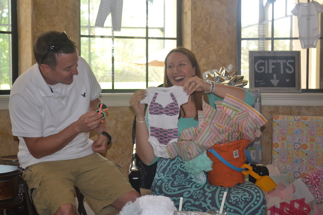 Charming Mint & Gray Baby Shower | Inspiration for planning a meaningful baby shower for a mom-to-be with creative ideas for decor, food, games, activities, a guest book, favors, and more! Here's a glimpse the mama and papa to be opening their gifts....