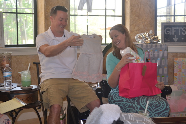 Charming Mint & Gray Baby Shower | Inspiration for planning a meaningful baby shower for a mom-to-be with creative ideas for decor, food, games, activities, a guest book, favors, and more! Here's a glimpse the mama and papa to be opening their gifts....