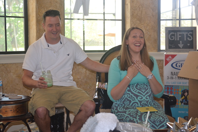 Charming Mint & Gray Baby Shower | Inspiration for planning a meaningful baby shower for a mom-to-be with creative ideas for decor, food, games, activities, a guest book, favors, and more! Here's a glimpse the mama and papa to be opening their gifts....