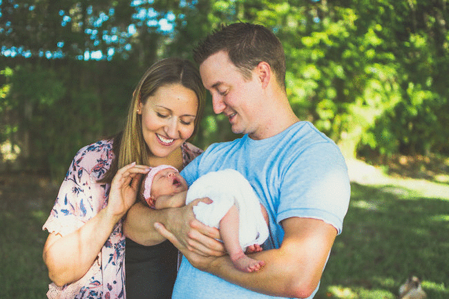 Juniper's 2 week newborn photography shoot: adorable hair bows, muslin swaddles, and a sweet smiling baby in a bucket. Brace yourself for the cuteness!