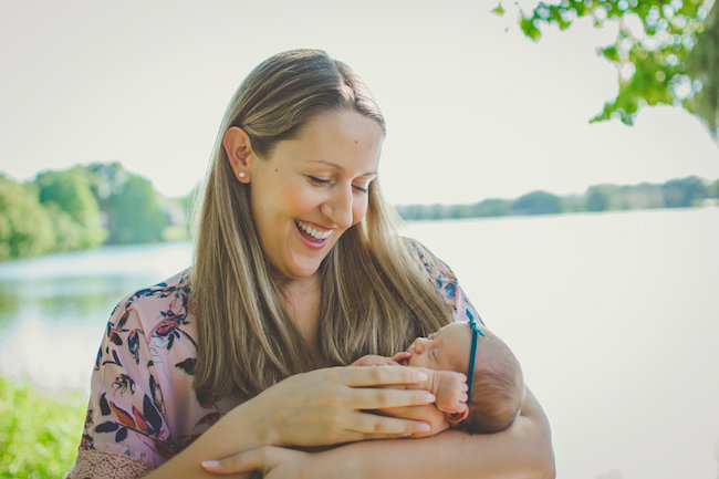 Juniper's 2 week newborn photography shoot: adorable hair bows, muslin swaddles, and a sweet smiling baby in a bucket. Brace yourself for the cuteness!