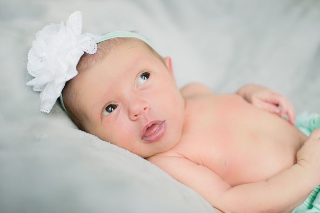 A suspicious glance from our sweet Juniper during her newborn shoot! Rocking the hair accessory like a boss baby.