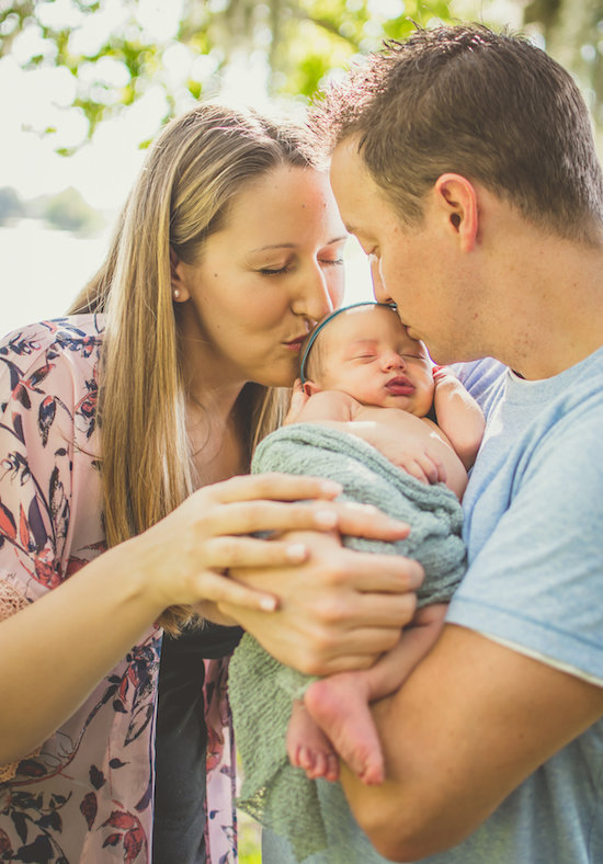 Juniper's 2 week newborn photography shoot: adorable hair bows, muslin swaddles, and a sweet smiling baby in a bucket. Brace yourself for the cuteness!
