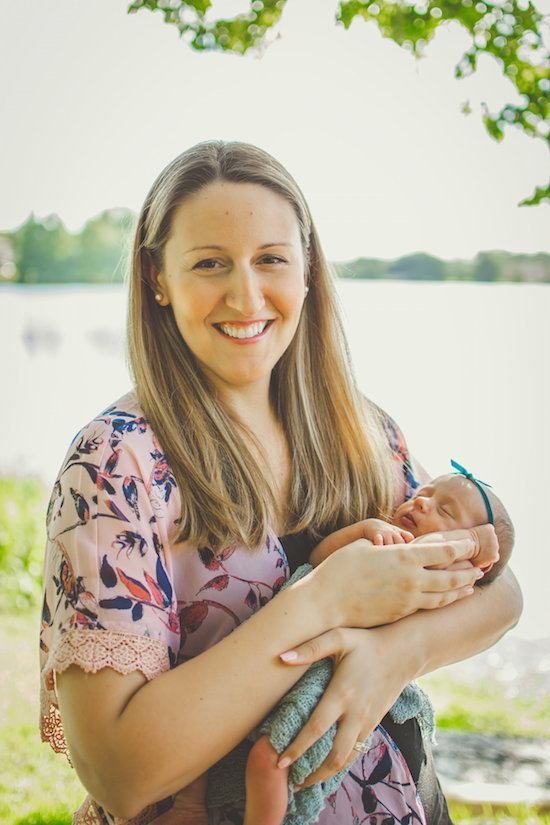 Juniper's 2 week newborn photography shoot: adorable hair bows, muslin swaddles, and a sweet smiling baby in a bucket. Brace yourself for the cuteness!