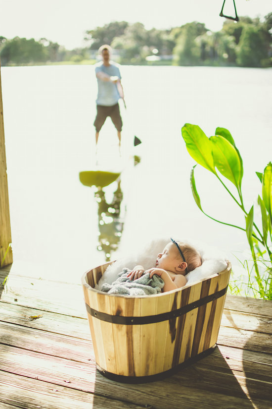 Juniper's 2 week newborn photography shoot: adorable hair bows, muslin swaddles, and a sweet smiling baby in a bucket. Brace yourself for the cuteness!
