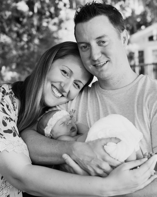 Juniper's 2 week newborn photography shoot: adorable hair bows, muslin swaddles, and a sweet smiling baby in a bucket. Brace yourself for the cuteness!