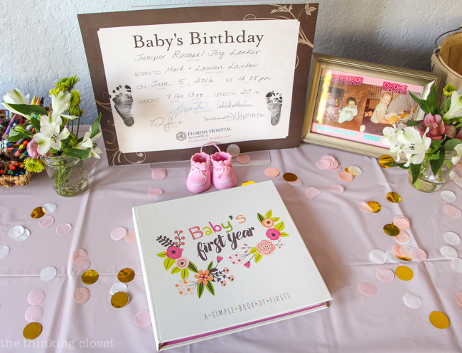 Baby Book on display at a Blooming First Birthday Bash, inspired by spring flowers in pink, blush, and white. DIY party ideas for a woodland floral-themed celebration, spring fling, or botanical garden party!