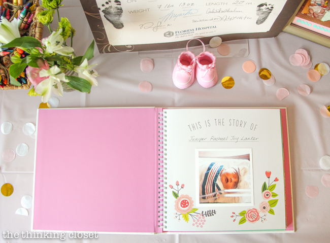 Baby Book on display at a Blooming First Birthday Bash, inspired by spring flowers in pink, blush, and white. DIY party ideas for a woodland floral-themed celebration, spring fling, or botanical garden party!