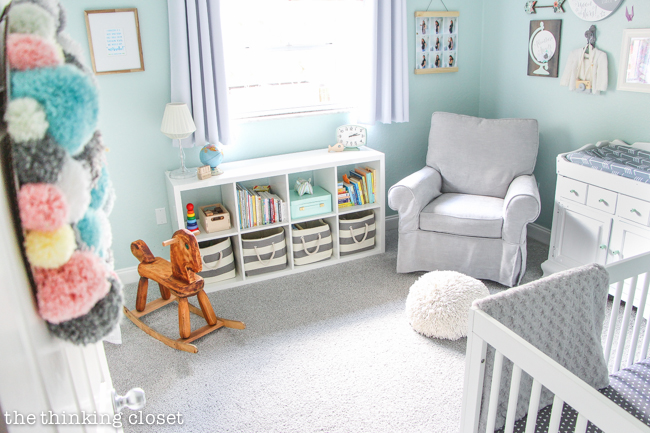 "Little Adventurer" Nursery Tour | An inspirational space with vintage-modern furniture, travel-themed decor, and a gender-neutral color palette of mint, gray, and white. This Comfort Swivel Rocker from Pottery Barn Kids in conjunction with the pouf from Land of Nod just make me want cuddle up for a nap! SO comfy.
