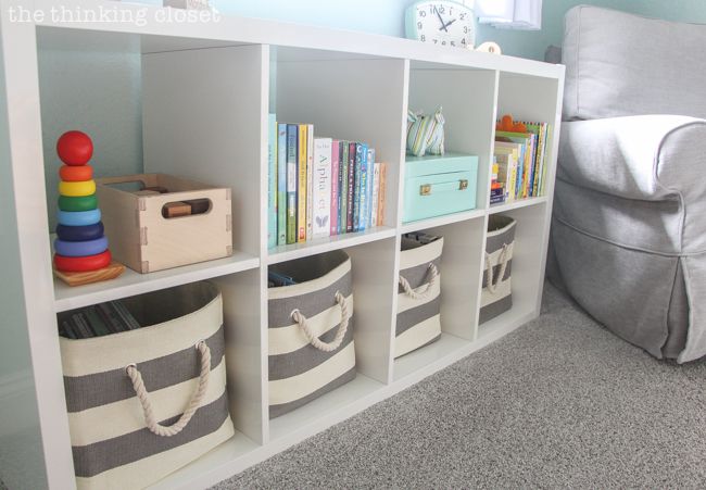 "Little Adventurer" Nursery Tour | An inspirational space with vintage-modern furniture, travel-themed decor, and a gender-neutral color palette of mint, gray, and white. Gotta love a bookshelf that has spots for books you're currently reading, books for when baby is a bit older (in the bins), and extra space to display favorite toys!