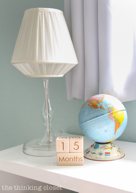 "Little Adventurer" Nursery Tour | An inspirational space with vintage-modern furniture, travel-themed decor, and a gender-neutral color palette of mint, gray, and white. Love these fun decor pieces atop the bookshelf!