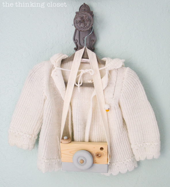 "Little Adventurer" Nursery Tour | An inspirational space with vintage-modern furniture, travel-themed decor, and a gender-neutral color palette of mint, gray, and white. This gallery wall is SO inspiring! I love the eclectic mix of DIY pieces, custom art, and vintage treasures (like this sweater that belonged to Lauren as a baby!).
