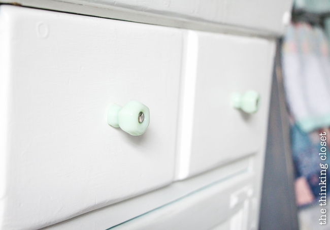 "Little Adventurer" Nursery Tour | An inspirational space with vintage-modern furniture, travel-themed decor, and a gender-neutral color palette of mint, gray, and white. I love this dry sink turned into diaper changing station...and the antique milk-green jadeite knobs from D. Lawless really add to the vintage vibe!