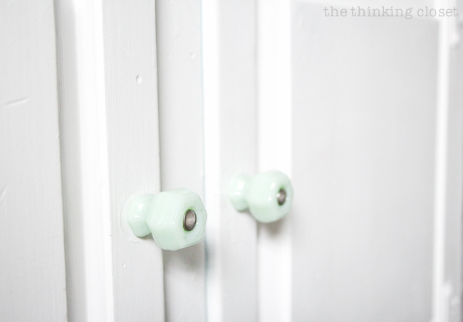 "Little Adventurer" Nursery Tour | An inspirational space with vintage-modern furniture, travel-themed decor, and a gender-neutral color palette of mint, gray, and white. I love this dry sink turned into diaper changing station...and the antique milk-green jadeite knobs from D. Lawless really add to the vintage vibe!
