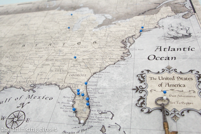 "Little Adventurer" Nursery Tour | An inspirational space with vintage-modern furniture, travel-themed decor, and a gender-neutral color palette of mint, gray, and white. Lovin' this travel map with blue pins to mark past adventures...and white pins to mark places yet to be explored....