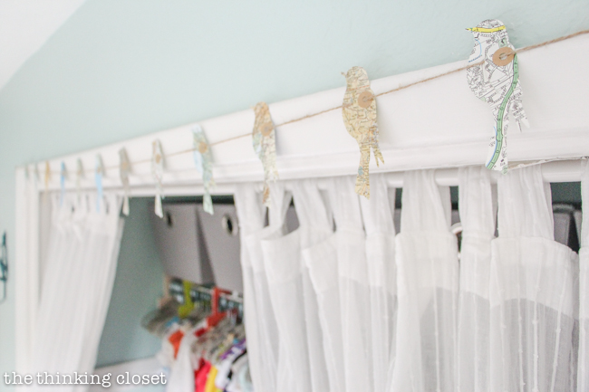"Little Adventurer" Nursery Tour | An inspirational space with vintage-modern furniture, travel-themed decor, and a gender-neutral color palette of mint, gray, and white. This open shelving closet makes the type A organizer in me swoon! Just remove the closet doors, install a few shelves, and start filling it up with totes and baskets. Pretty AND functional. I can dig it!