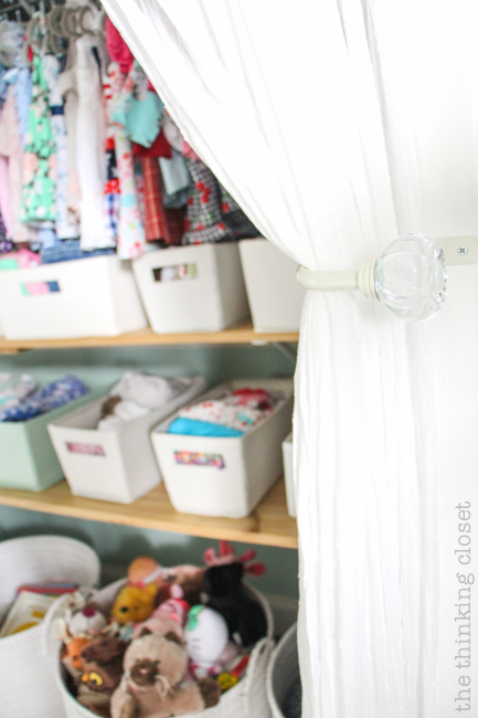 "Little Adventurer" Nursery Tour | An inspirational space with vintage-modern furniture, travel-themed decor, and a gender-neutral color palette of mint, gray, and white. This open shelving closet makes the type A organizer in me swoon! Just remove the closet doors, install a few shelves, and start filling it up with totes and baskets. Pretty AND functional. I can dig it!