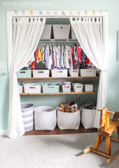 "Little Adventurer" Nursery Tour | An inspirational space with vintage-modern furniture, travel-themed decor, and a gender-neutral color palette of mint, gray, and white. This open shelving closet makes the type A organizer in me swoon! Just remove the closet doors, install a few shelves, and start filling it up with totes and baskets. Pretty AND functional. I can dig it!
