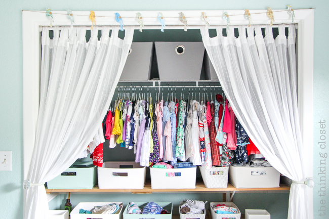"Little Adventurer" Nursery Tour | An inspirational space with vintage-modern furniture, travel-themed decor, and a gender-neutral color palette of mint, gray, and white. This open shelving closet makes the type A organizer in me swoon! Just remove the closet doors, install a few shelves, and start filling it up with totes and baskets. Pretty AND functional. I can dig it!