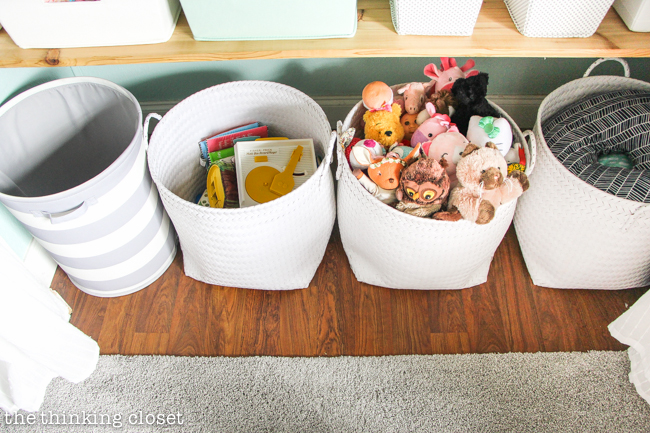 "Little Adventurer" Nursery Tour | An inspirational space with vintage-modern furniture, travel-themed decor, and a gender-neutral color palette of mint, gray, and white. This open shelving closet makes the type A organizer in me swoon! Just remove the closet doors, install a few shelves, and start filling it up with totes and baskets. Pretty AND functional. I can dig it!