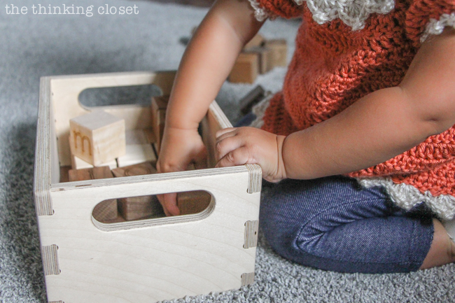 "Little Adventurer" Nursery Tour | An inspirational space with vintage-modern furniture, travel-themed decor, and a gender-neutral color palette of mint, gray, and white. Time to play with some alphabet blocks by Little Sapling Toys!