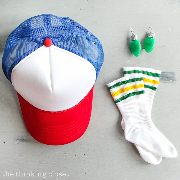"Stranger Things" & "Eleven" Punny Halloween Costume for a Family of 3 with a baby or toddler! Here's the inside scoop for how we pulled together our creative punny Halloween costumes featuring 011, Dustin, & Joyce Byers...including a D.I.Y. tutorial for making Eleven's iconic tube socks in baby size. Also, check out our punny Halloween costumes from the past 5 years! So many great last-minute costumes in this mix.