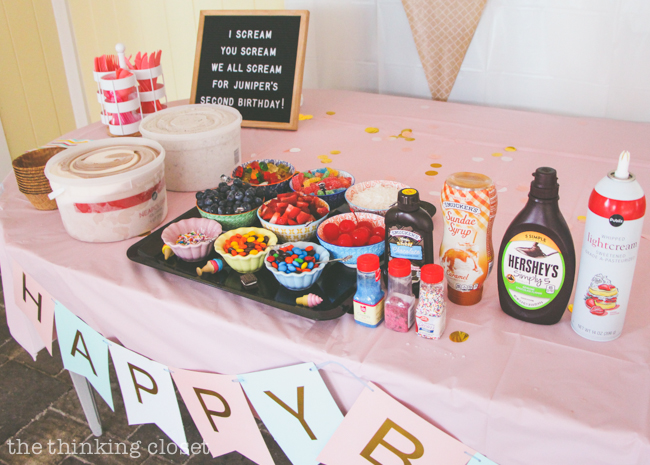 Ice Cream Sundae Station with so many yummy topping options at an Ice Cream Themed Birthday Party Lovin' the DIY party ideas from this 2nd birthday celebration. Inexpensive and do-able ideas you can pull of in the last minute! From backdrops to lawn decor to favors to letter-board quotes!
