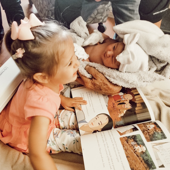 Big sister Juniper meets Pepper, and receives a My Neighbor Totoro book from her! | Pepper's Birth Story via ThinkingCloset.com