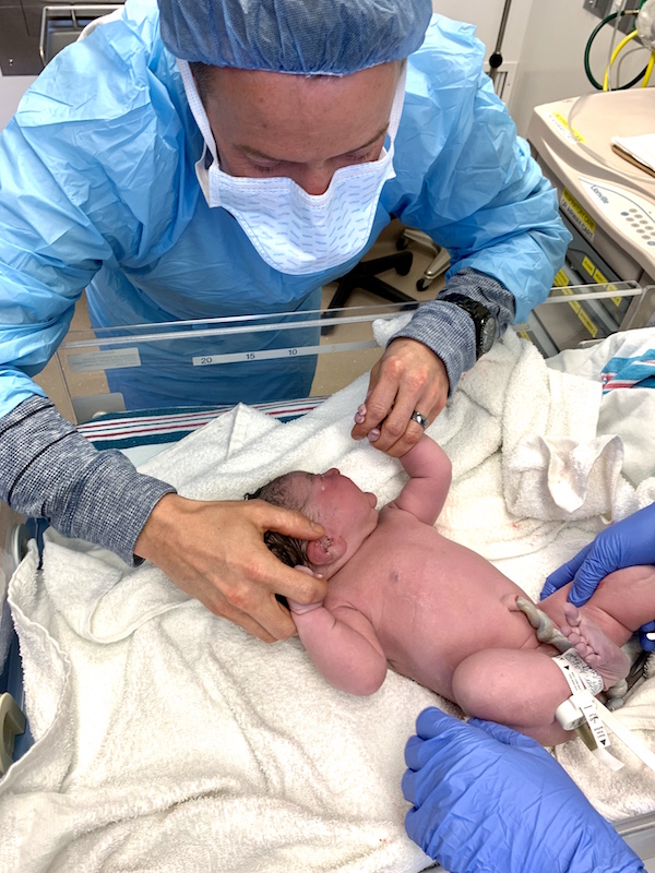 Daddy comforts you on the warmer. | Pepper's Birth Story via ThinkingCloset.com