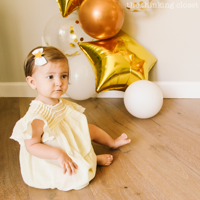 A star hair-clip bow and a vintage yellow dress for the birthday girl! | A "Twinkle Twinkle Little Star" 1st Birthday Party, inspired by our favorite baby lullaby. DIY party ideas for a dazzling celebration for your shining star's first birthday or baby shower!
