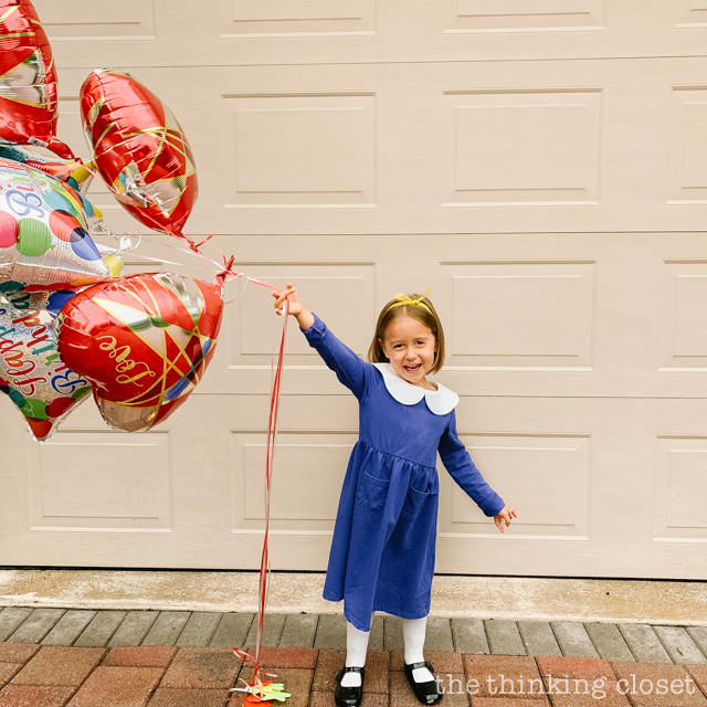 Juniper dressed the part of Madeline for her birthday party day! | How to host a "Madeline In Paris"-themed 4th birthday party at home with creative DIY party activities, French decor, and costumes inspired by the classic Madeline children's books via ThinkingCloset.com