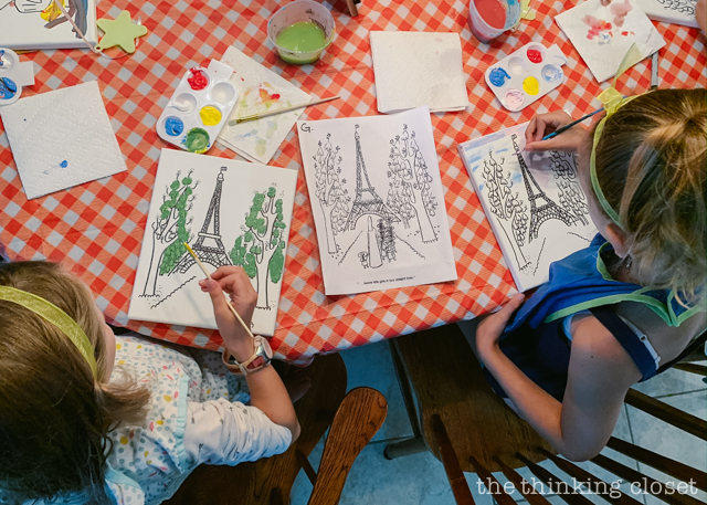 Each party guest got to paint their own art canvas at The Louvre. Each canvas featured a classic scene from Madeline (pre-selected by the kids), and they each got to take home their masterpiece as a party favor! | How to host a "Madeline In Paris"-themed 4th birthday party at home with creative DIY party activities, French decor, and costumes inspired by the classic Madeline children's books via ThinkingCloset.com