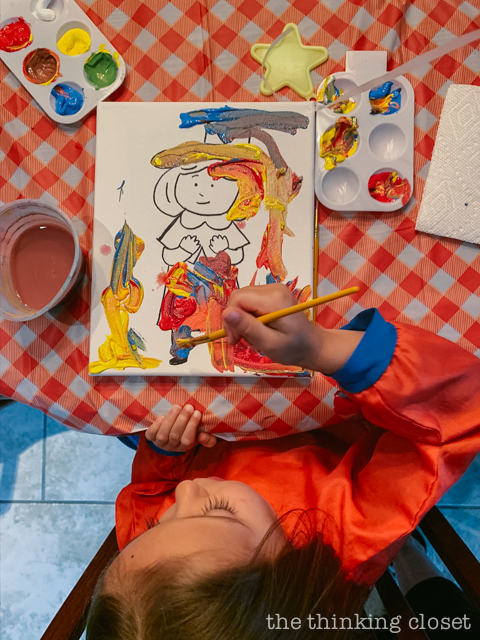 Each party guest got to paint their own art canvas at The Louvre. Each canvas featured a classic scene from Madeline (pre-selected by the kids), and they each got to take home their masterpiece as a party favor! | How to host a "Madeline In Paris"-themed 4th birthday party at home with creative DIY party activities, French decor, and costumes inspired by the classic Madeline children's books via ThinkingCloset.com