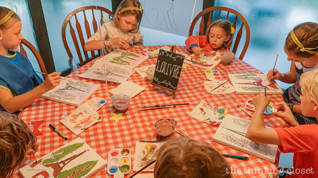 Each party guest got to paint their own art canvas at The Louvre. Each canvas featured a classic scene from Madeline (pre-selected by the kids), and they each got to take home their masterpiece as a party favor! | How to host a "Madeline In Paris"-themed 4th birthday party at home with creative DIY party activities, French decor, and costumes inspired by the classic Madeline children's books via ThinkingCloset.com