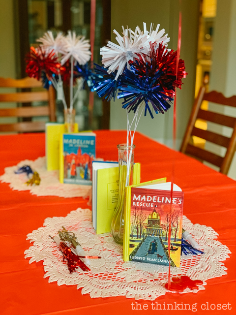 For table centerpieces, I repurposed some Fourth of July picks for our French flag colored decor along with our mini Madeline books on display! We had Eiffel towers, too! | How to host a "Madeline In Paris"-themed 4th birthday party at home with creative DIY party activities, French decor, and costumes inspired by the classic Madeline children's books via ThinkingCloset.com