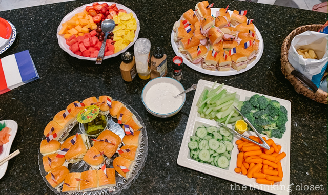 We offered a light Parisian-style lunch of sandwiches decorated with French flag toothpicks! | How to host a "Madeline In Paris"-themed 4th birthday party at home with creative DIY party activities, French decor, and costumes inspired by the classic Madeline children's books via ThinkingCloset.com