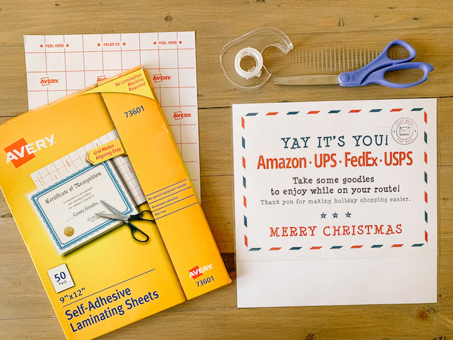 Laminating the sign for our Delivery Drivers Holiday Treats Station | Video & photo tutorial for how to set up a Holiday Treats Station on your porch with snacks & drinks for your neighborhood delivery drivers & U.S.P.S. workers. A simple way to make someone's day & show gratitude to our essential workers this Christmas season!