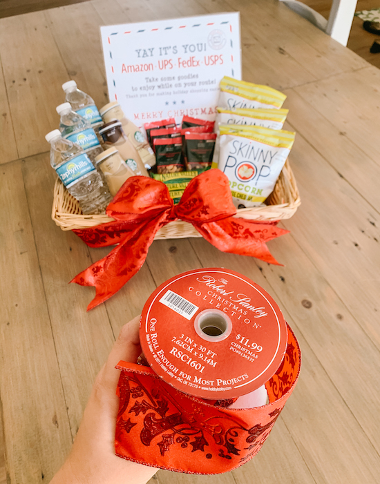 Adding a Festive Red Bow to our Delivery Drivers Holiday Treats Station | Video & photo tutorial for how to set up a Holiday Treats Station on your porch with snacks & drinks for your neighborhood delivery drivers & U.S.P.S. workers. A simple way to make someone's day & show gratitude to our essential workers this Christmas season!