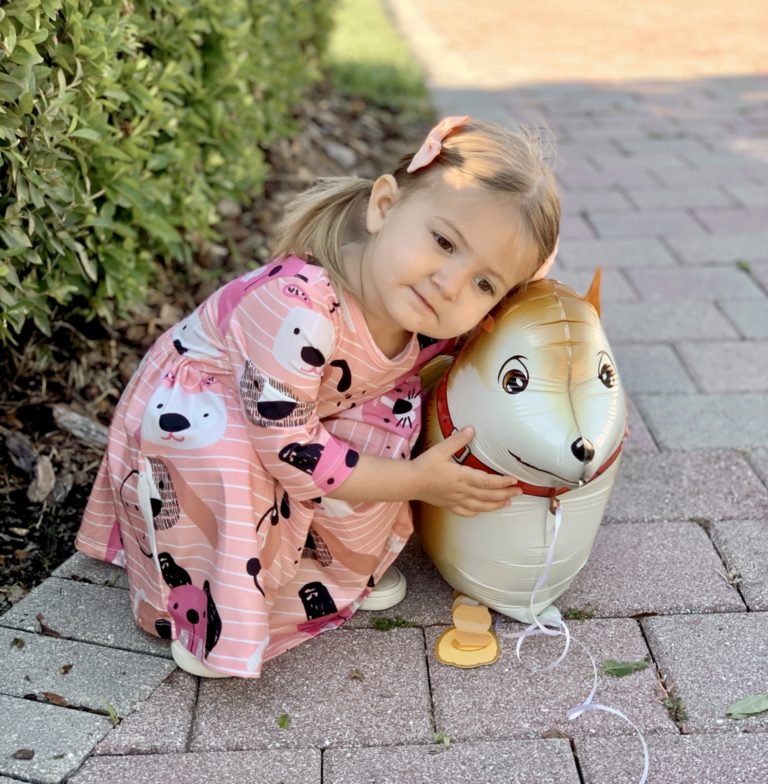Pepper's 2nd Birthday "Puppy Paw-ty!" Creative party ideas via thinkingcloset.com - Doggy days pocket twirl dress with walking dog balloon for the cutest driveway photo shoot pre-party!